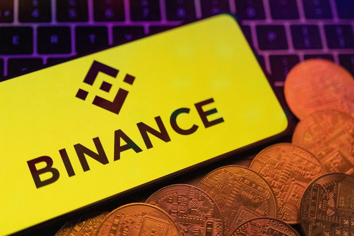 Akıllı telefon ekranında Binance logosu ve kripto paralar (haber görseli)